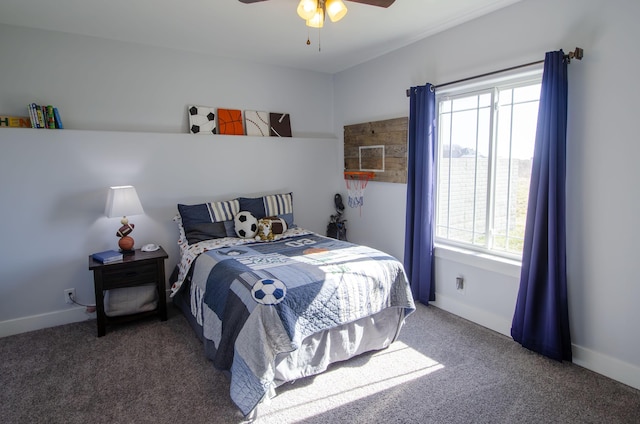 bedroom with baseboards, dark carpet, and a ceiling fan