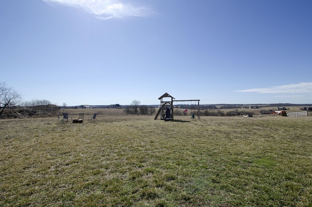 view of yard with a playground and a rural view