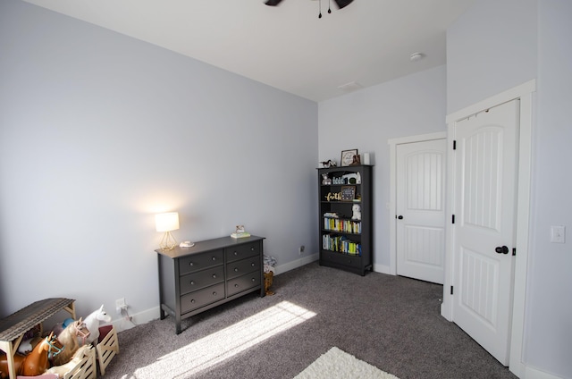 bedroom with baseboards and dark colored carpet