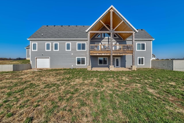 back of property featuring an attached garage, a yard, and a patio area