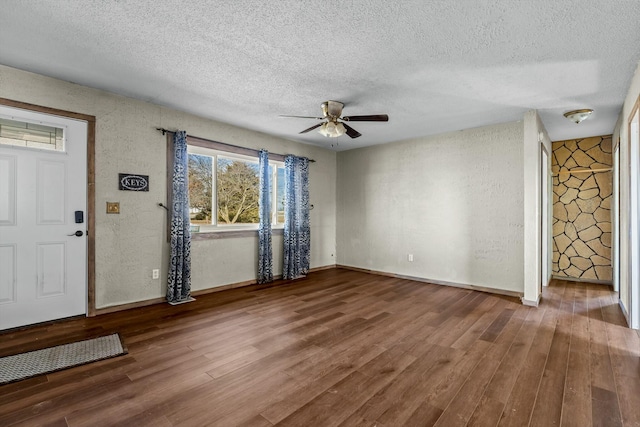 foyer featuring a textured ceiling and wood finished floors