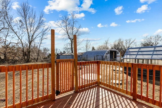 wooden deck with an outbuilding