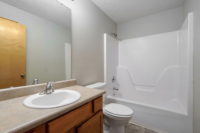 bathroom with toilet, shower / bath combination, a textured ceiling, and vanity