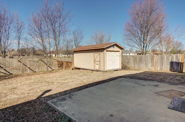 view of yard with an outbuilding, a fenced backyard, and a shed