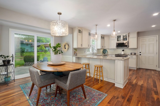 dining room featuring dark wood finished floors and recessed lighting