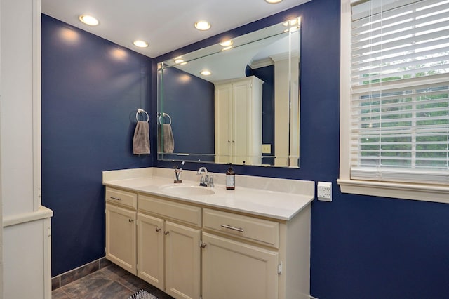 bathroom featuring recessed lighting, baseboards, and vanity