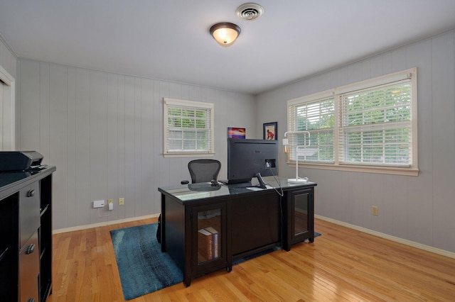 office space featuring baseboards, visible vents, and light wood-style floors