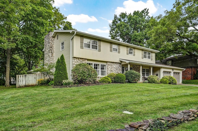 view of front of property with a garage, stone siding, fence, and a front yard