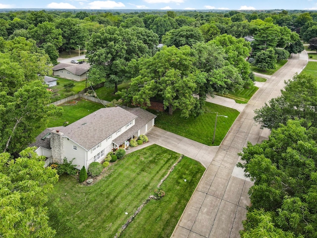 birds eye view of property featuring a view of trees