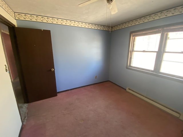 carpeted empty room featuring a ceiling fan, baseboards, and baseboard heating