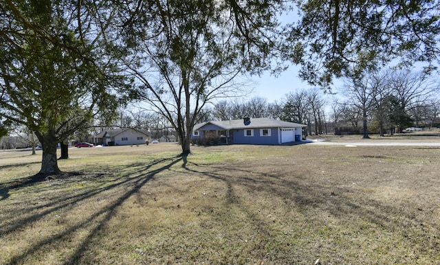 view of front facade with a garage and a front lawn