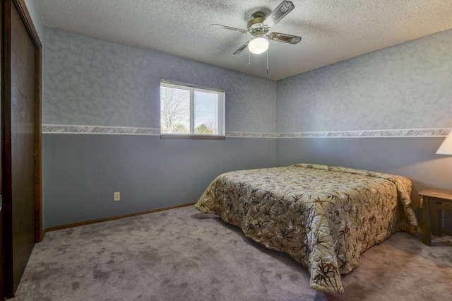 bedroom with light carpet, ceiling fan, baseboards, and a textured ceiling