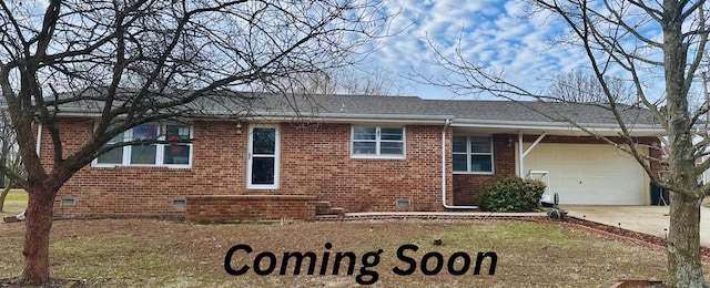 view of front of home featuring a garage, concrete driveway, brick siding, and crawl space