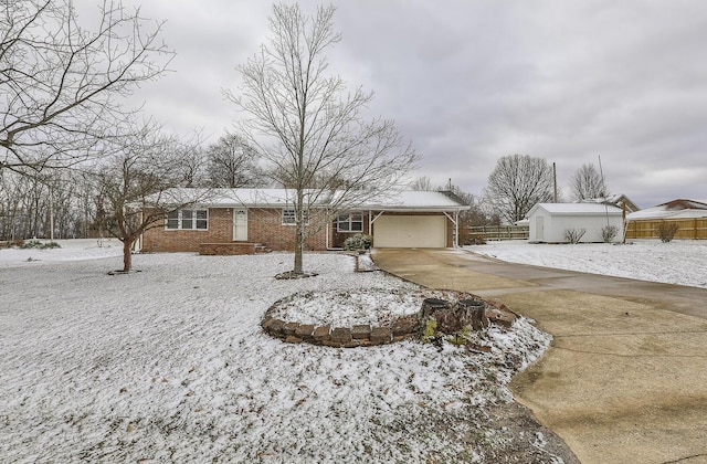 single story home with driveway, an attached garage, fence, and brick siding