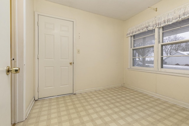 spare room with light floors and baseboards