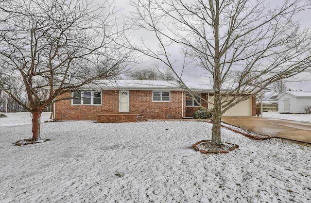 ranch-style house with crawl space, brick siding, driveway, and an attached garage