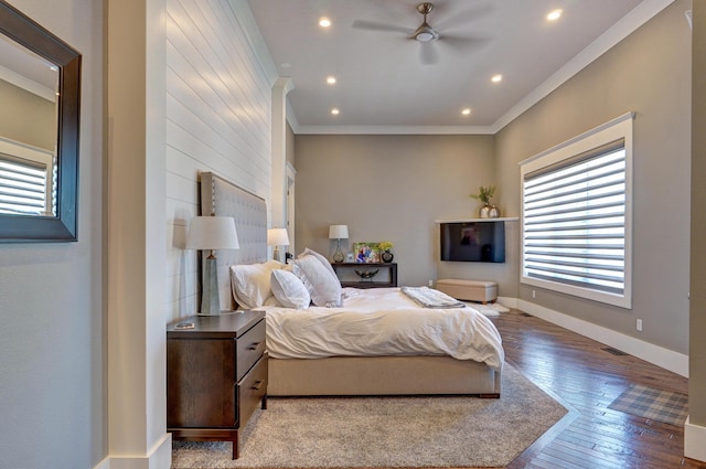 bedroom featuring crown molding, hardwood / wood-style flooring, multiple windows, and baseboards