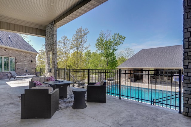 view of patio featuring fence, a fenced in pool, and an outdoor fire pit