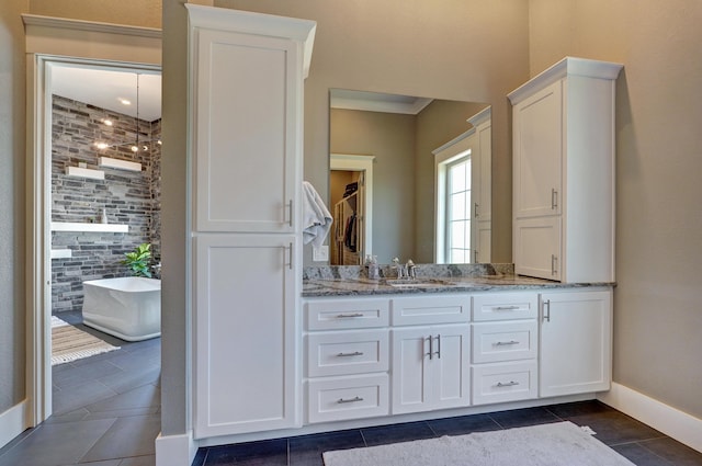 full bathroom featuring tiled shower, a freestanding bath, vanity, and tile patterned flooring