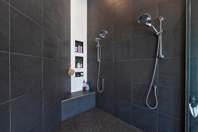 full bath with a tile shower