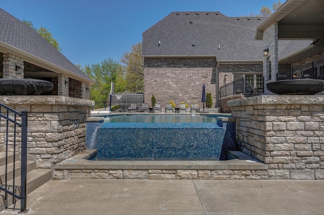 view of swimming pool with a patio area, a fenced in pool, and fence