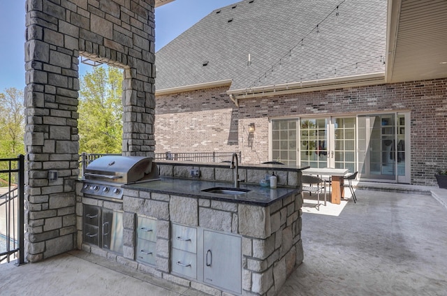 view of patio featuring area for grilling and a sink