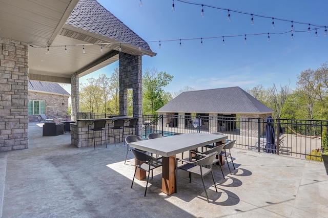 view of patio featuring outdoor dining area and fence