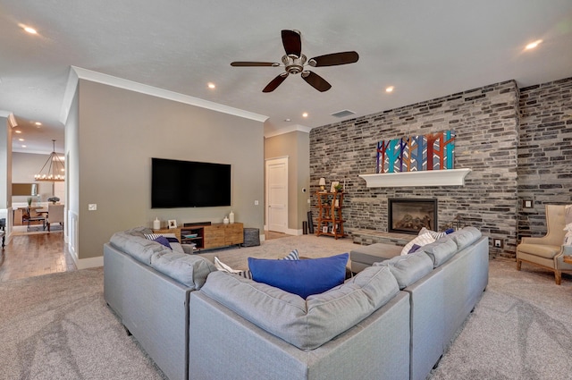 living room with recessed lighting, visible vents, a glass covered fireplace, and crown molding