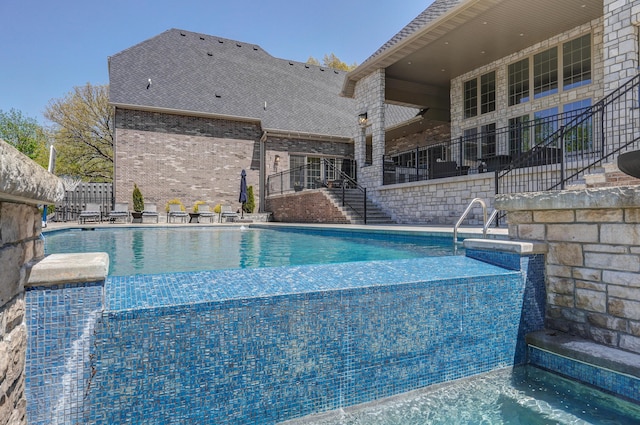 pool featuring stairs, a patio, and fence