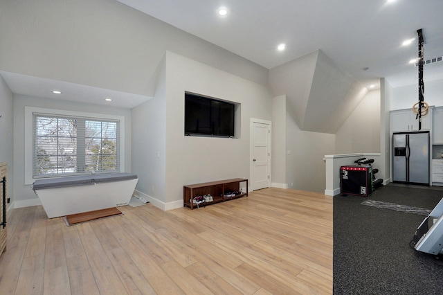 living room with recessed lighting, visible vents, baseboards, and light wood finished floors