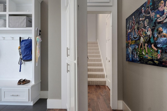 mudroom with dark wood-style floors and baseboards