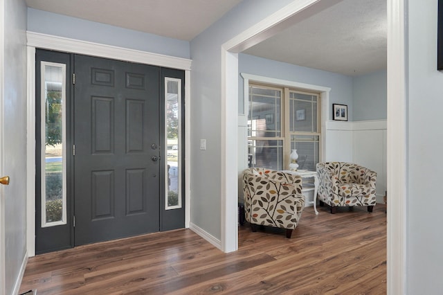 foyer entrance with dark wood-type flooring