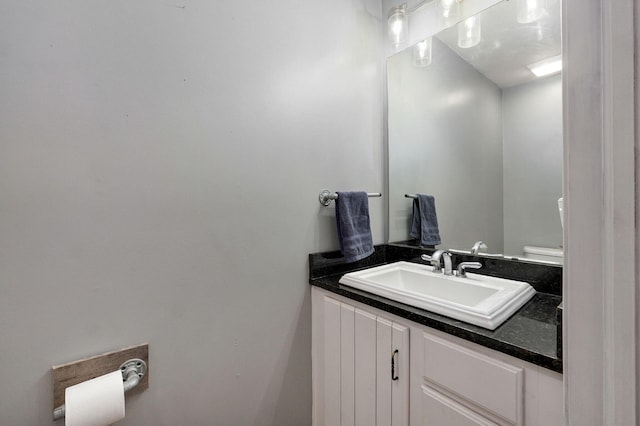 half bath featuring toilet and vanity