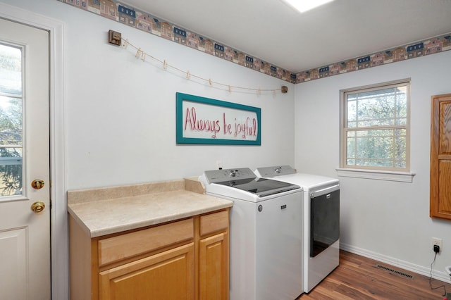 laundry room with cabinet space, baseboards, visible vents, dark wood-type flooring, and separate washer and dryer