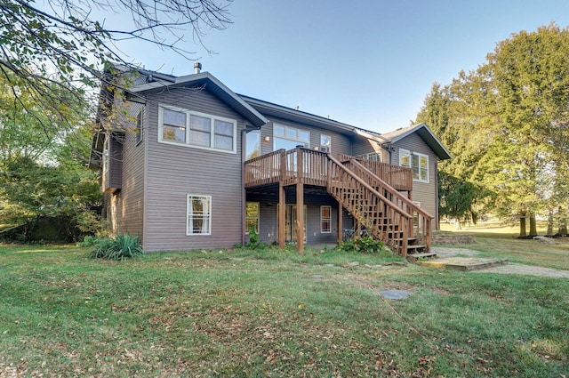 back of house with stairway, a deck, and a yard