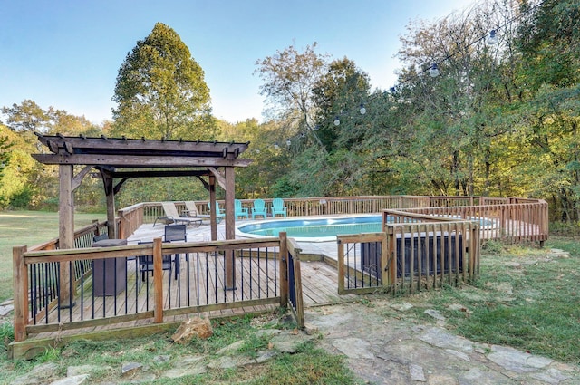 view of pool with a pergola, a deck, and a fenced in pool