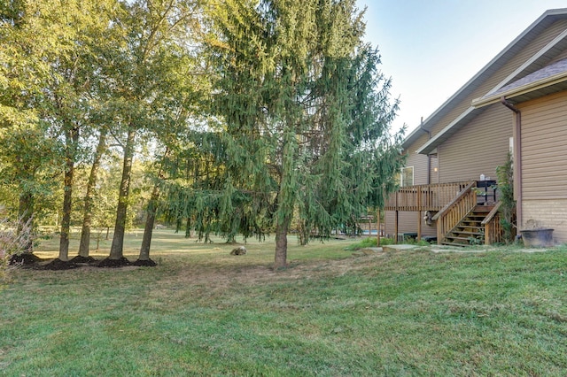 view of yard featuring stairs and a deck