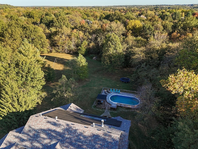 birds eye view of property with a wooded view