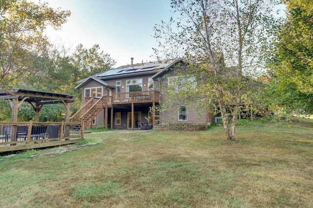 rear view of house featuring stairs, a yard, a deck, and a pergola