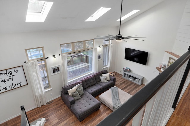 living area featuring high vaulted ceiling, dark wood finished floors, baseboards, and ceiling fan