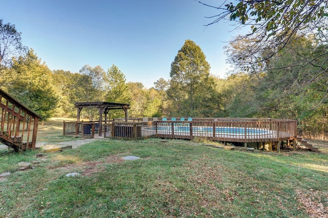 view of yard featuring a fenced in pool, a deck, and a pergola