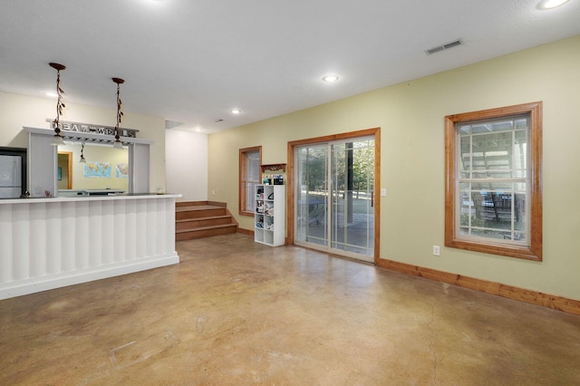 interior space with recessed lighting, visible vents, baseboards, finished concrete flooring, and stairs