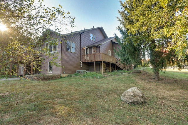 rear view of house with a yard, stairway, cooling unit, and a wooden deck