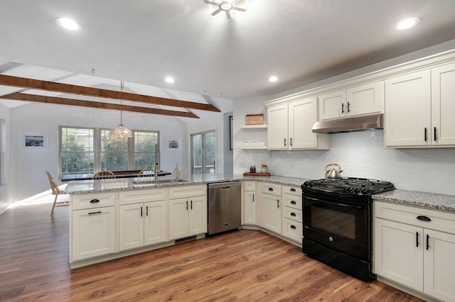 kitchen with black range with gas cooktop, under cabinet range hood, a peninsula, hanging light fixtures, and stainless steel dishwasher