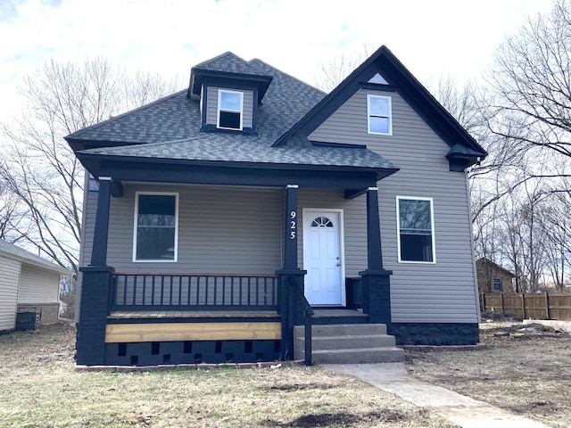 view of front of property with a porch and roof with shingles