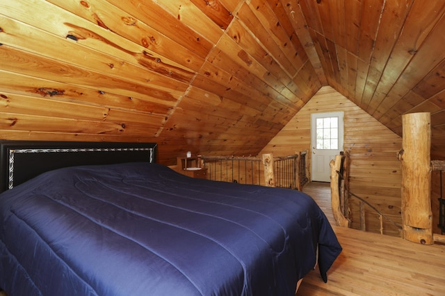 bedroom with vaulted ceiling, wood finished floors, wood ceiling, and wooden walls