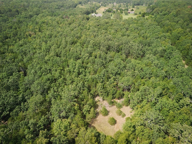 drone / aerial view featuring a forest view