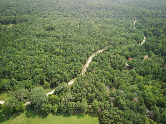 bird's eye view featuring a wooded view