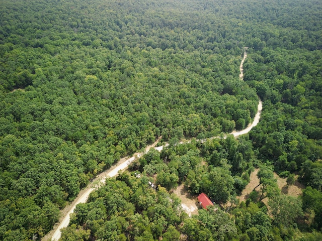 birds eye view of property with a view of trees