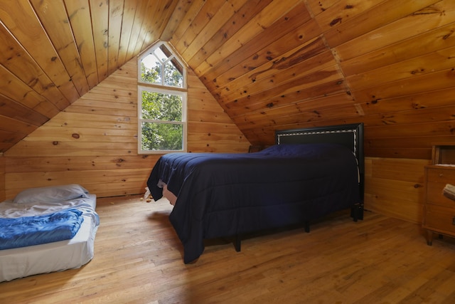 bedroom with light wood-style floors, lofted ceiling, wooden ceiling, and wooden walls